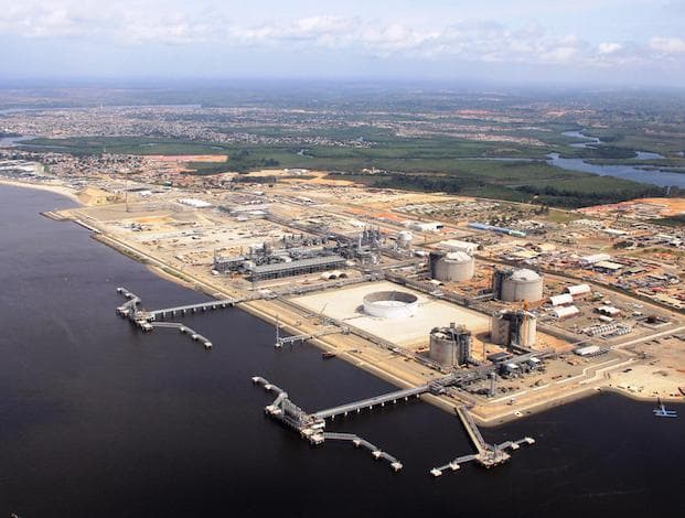 Aerial view of an LNG terminal with storage tanks and jetties